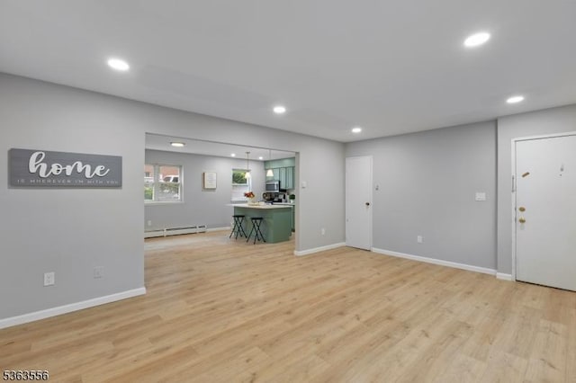 2467 State Route 10, Parsippany-Troy Hills Twp, NJ 07950 - unfurnished living room with a baseboard radiator, recessed lighting, and light wood finished floors
