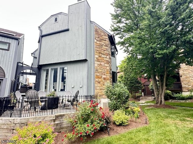 43 Kensington Ct, Washington Twp, NJ 07840 - back of house with a patio, a chimney, and a lawn