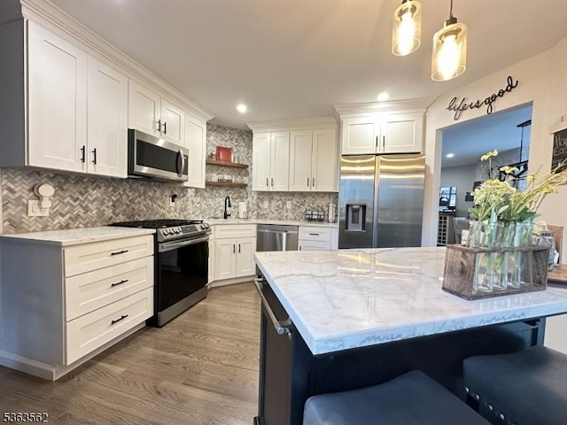 43 Kensington Ct, Washington Twp, NJ 07840 - kitchen with stainless steel appliances, a sink, wood finished floors, white cabinetry, and recessed lighting