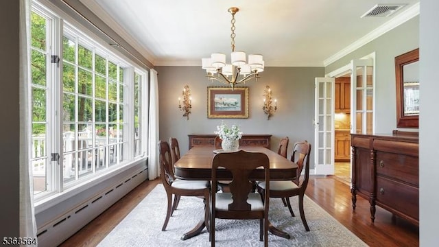 80 Clark Rd, Bernardsville Boro, NJ 07924 - dining area with a baseboard radiator, a chandelier, wood finished floors, and crown molding