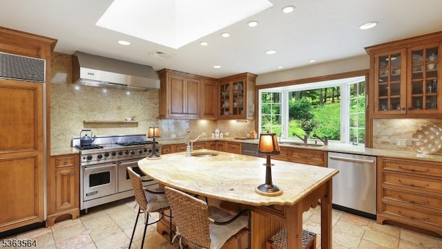 80 Clark Rd, Bernardsville Boro, NJ 07924 - kitchen featuring wall chimney exhaust hood, premium appliances, brown cabinets, recessed lighting, and light stone counters
