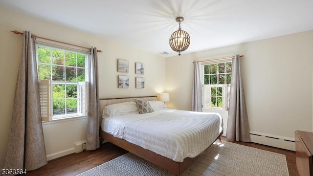 80 Clark Rd, Bernardsville Boro, NJ 07924 - bedroom with a baseboard heating unit, a chandelier, and wood finished floors
