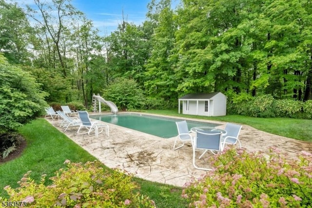 11 Carteret Trl, Bernards Twp, NJ 07920 - outdoor pool featuring a water slide, a patio, a yard, and a storage unit