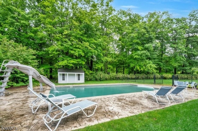 11 Carteret Trl, Bernards Twp, NJ 07920 - view of swimming pool featuring a water slide, an outdoor structure, a patio, and view of wooded area