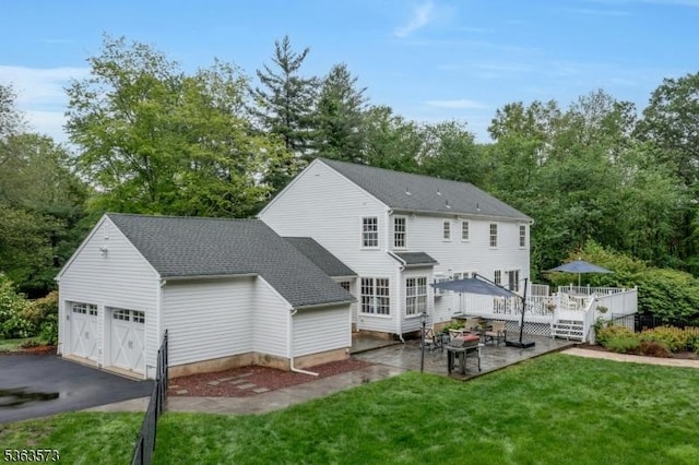 11 Carteret Trl, Bernards Twp, NJ 07920 - rear view of property with a yard, a deck, a garage, view of wooded area, and a patio