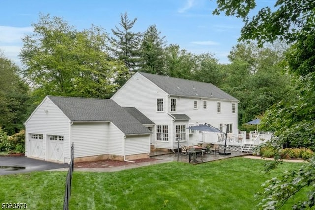 11 Carteret Trl, Bernards Twp, NJ 07920 - back of property featuring a lawn, a wooden deck, view of scattered trees, and a garage