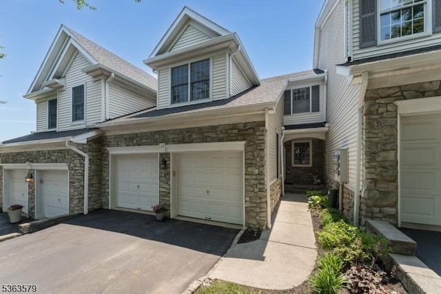 22 La Costa Dr, Clinton Twp, NJ 08801 - view of front of house featuring stone siding, an attached garage, and roof with shingles