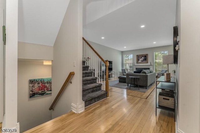 22 La Costa Dr, Clinton Twp, NJ 08801 - staircase with wood finished floors, a fireplace, and recessed lighting