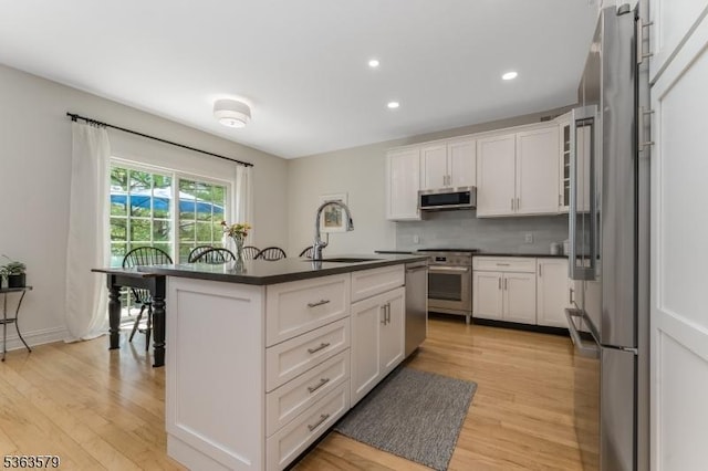 22 La Costa Dr, Clinton Twp, NJ 08801 - kitchen featuring stainless steel appliances, dark countertops, light wood-type flooring, white cabinets, and recessed lighting