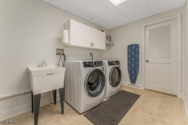 22 La Costa Dr, Clinton Twp, NJ 08801 - laundry area with cabinet space, light tile patterned flooring, and washer and clothes dryer