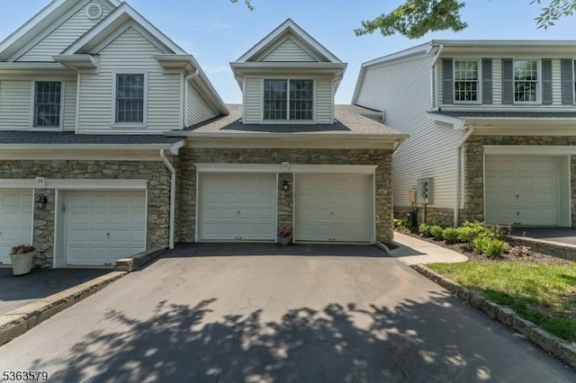 22 La Costa Dr, Clinton Twp, NJ 08801 - view of front facade featuring stone siding, asphalt driveway, and a garage