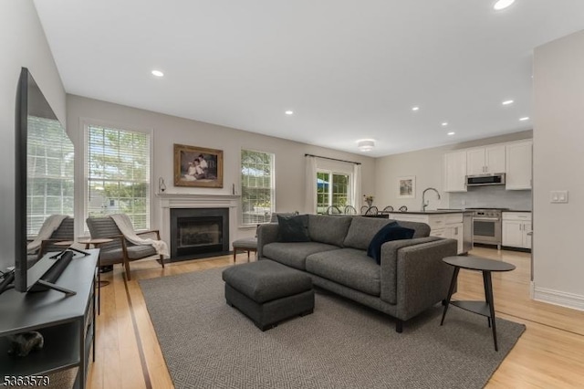 22 La Costa Dr, Clinton Twp, NJ 08801 - living room featuring a fireplace with flush hearth, light wood-type flooring, and recessed lighting