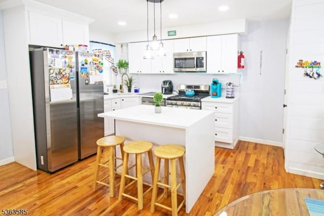 281 Oregon St, Union Twp, NJ 07088 - kitchen with stainless steel appliances, a kitchen breakfast bar, white cabinetry, light countertops, and recessed lighting