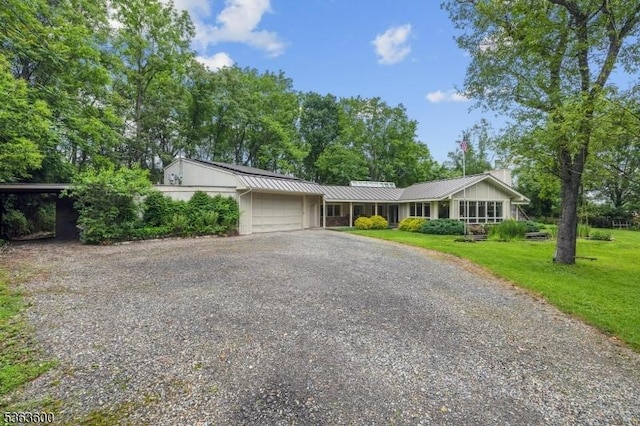 525 Watters Rd, Mansfield Twp, NJ 07840 - single story home with gravel driveway, a chimney, an attached garage, a front lawn, and a metal roof