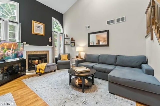 32 Ryan Ln, Lincoln Park Boro, NJ 07035 - living room with high vaulted ceiling, wood finished floors, plenty of natural light, and a glass covered fireplace