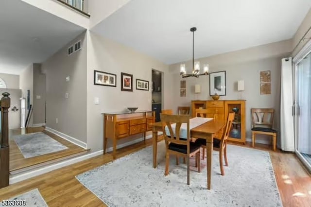 32 Ryan Ln, Lincoln Park Boro, NJ 07035 - dining area with wood finished floors and a chandelier