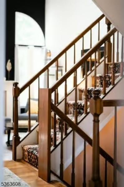 32 Ryan Ln, Lincoln Park Boro, NJ 07035 - staircase with wood finished floors, a towering ceiling, and plenty of natural light