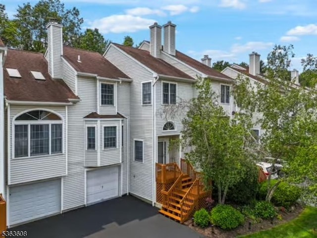 32 Ryan Ln, Lincoln Park Boro, NJ 07035 - view of front of property featuring a garage and asphalt driveway