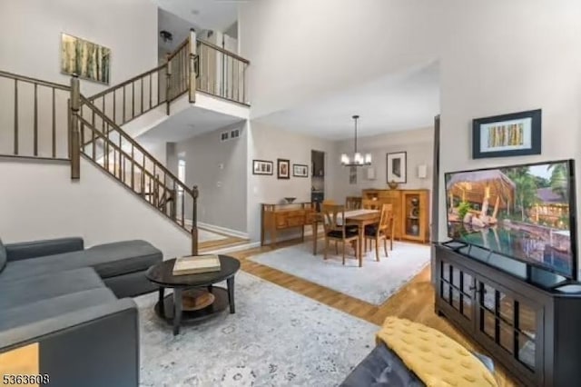 32 Ryan Ln, Lincoln Park Boro, NJ 07035 - living room with wood finished floors, stairway, a chandelier, and a high ceiling