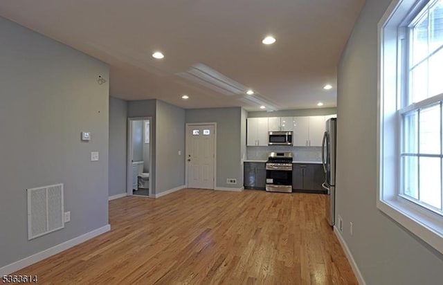 1121 Frank St, Roselle Boro, NJ 07203 - unfurnished living room with light wood-style flooring, recessed lighting, and baseboards