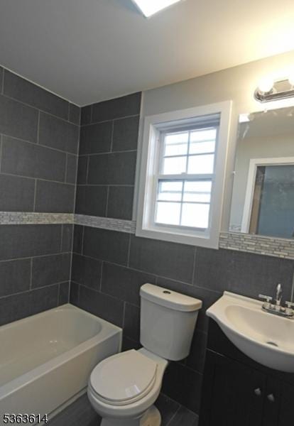 1121 Frank St, Roselle Boro, NJ 07203 - full bathroom with tile walls, vanity, toilet, and shower / tub combination
