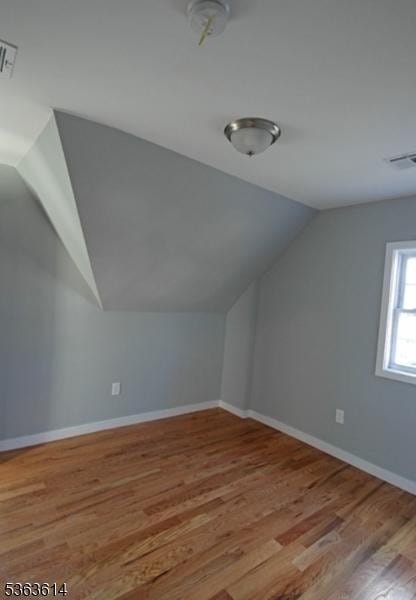 1121 Frank St, Roselle Boro, NJ 07203 - additional living space with vaulted ceiling, wood finished floors, and baseboards