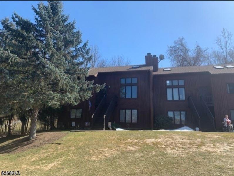 5 Pevero Dr Unit 4, Vernon Twp, NJ 07462 - rear view of property featuring stairway, a lawn, and a chimney