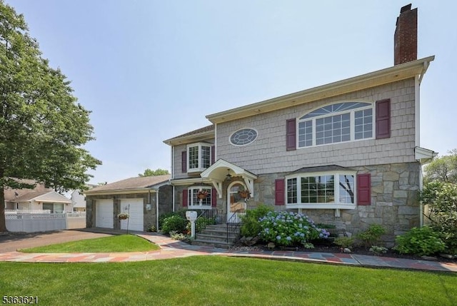 44 Shetland Dr, Clark Twp, NJ 07066 - view of front of home with stone siding, a chimney, an attached garage, and driveway
