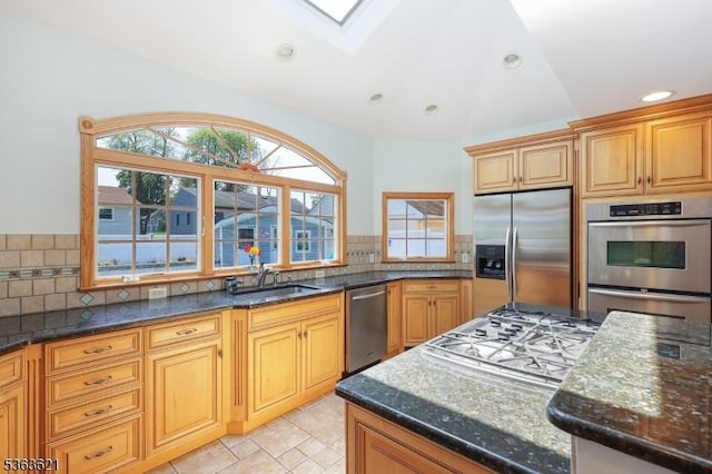 44 Shetland Dr, Clark Twp, NJ 07066 - kitchen with appliances with stainless steel finishes, vaulted ceiling, dark stone countertops, backsplash, and a skylight