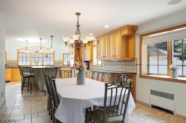 44 Shetland Dr, Clark Twp, NJ 07066 - dining area with radiator, a chandelier, recessed lighting, and stone tile flooring