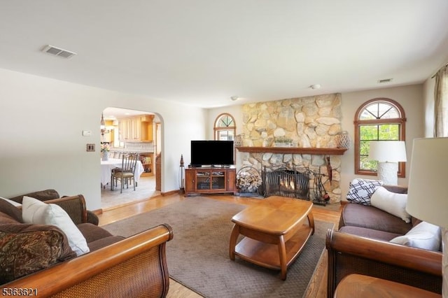 44 Shetland Dr, Clark Twp, NJ 07066 - living area featuring arched walkways, light wood-type flooring, and a fireplace