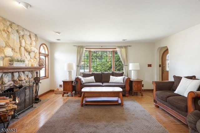 44 Shetland Dr, Clark Twp, NJ 07066 - living room with wood finished floors, arched walkways, and a fireplace