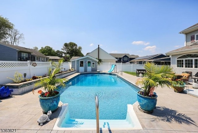 44 Shetland Dr, Clark Twp, NJ 07066 - view of pool with a water slide, a fenced backyard, a patio, and an outdoor structure