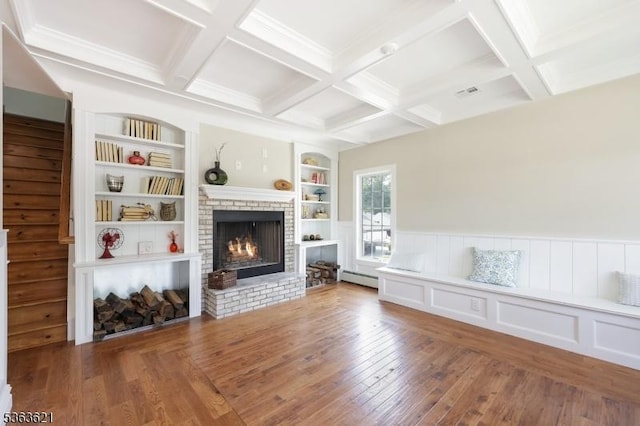 44 Shetland Dr, Clark Twp, NJ 07066 - living area with a brick fireplace, wood-type flooring, baseboard heating, built in features, and a wainscoted wall