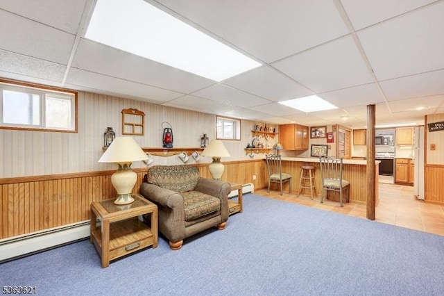 44 Shetland Dr, Clark Twp, NJ 07066 - living room featuring a drop ceiling, baseboard heating, a dry bar, a baseboard heating unit, and wooden walls