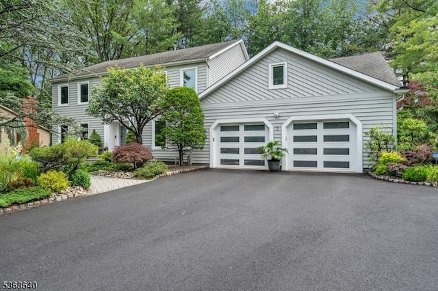 5 Leighton Dr, East Brunswick Twp, NJ 08816 - view of front facade with asphalt driveway, a garage, and roof with shingles