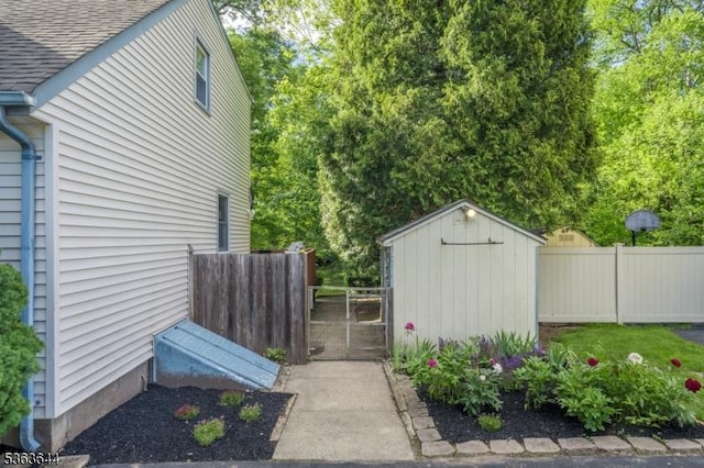27 Brook Rd, New Providence Boro, NJ 07974 - view of side of home featuring a storage shed, roof with shingles, and a gate