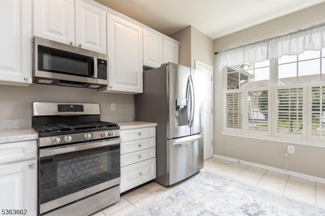 15 Fernwood Ct, Readington Twp, NJ 08889 - kitchen featuring stainless steel appliances, light tile patterned flooring, and white cabinetry