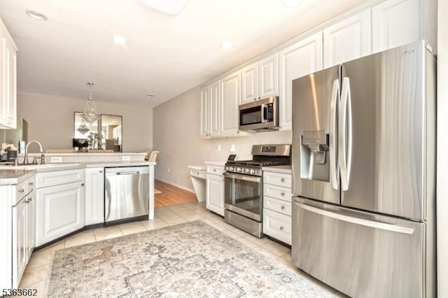 15 Fernwood Ct, Readington Twp, NJ 08889 - kitchen with appliances with stainless steel finishes, light tile patterned floors, white cabinets, and light countertops
