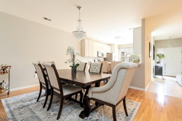 15 Fernwood Ct, Readington Twp, NJ 08889 - dining area featuring light wood finished floors and a chandelier
