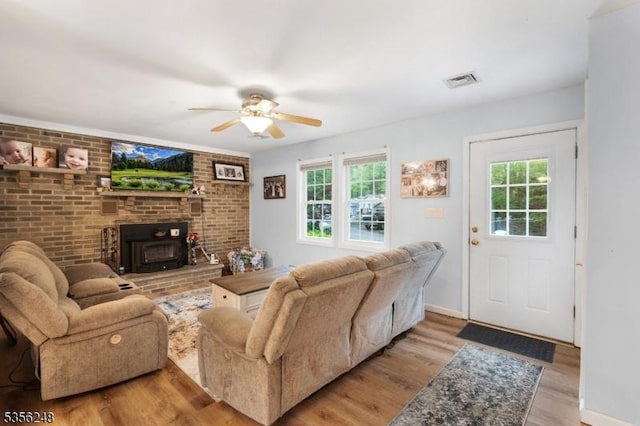 54 Stevens Trl, Hopatcong Boro, NJ 07843 - living area featuring healthy amount of natural light, wood finished floors, ceiling fan, and a wood stove