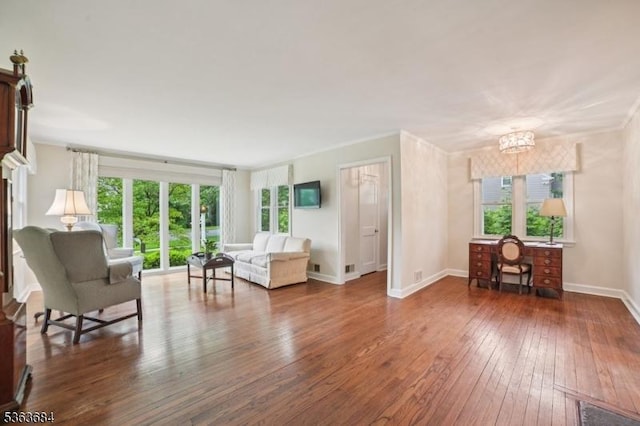 135 Weston Ave, Chatham Boro, NJ 07928 - living room with wood-type flooring, healthy amount of natural light, crown molding, and a chandelier