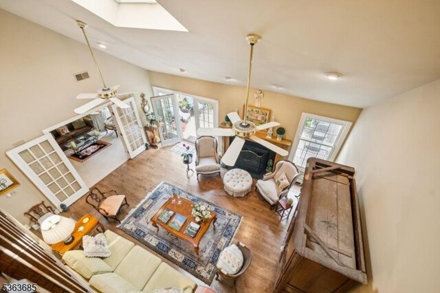 48 Dexter Dr N, Bernards Twp, NJ 07920 - living room with wood finished floors, a skylight, a ceiling fan, and vaulted ceiling