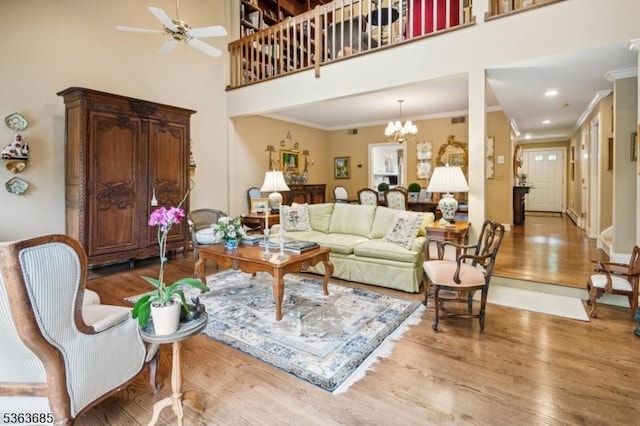 48 Dexter Dr N, Bernards Twp, NJ 07920 - living room featuring wood finished floors, a high ceiling, crown molding, a ceiling fan, and a chandelier