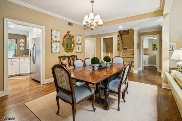 48 Dexter Dr N, Bernards Twp, NJ 07920 - dining space featuring stairway, a chandelier, wood finished floors, and crown molding