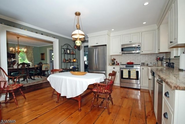 1135 State Route 28, Branchburg Twp, NJ 08876 - kitchen with appliances with stainless steel finishes, white cabinets, a chandelier, pendant lighting, and tasteful backsplash
