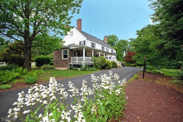 1135 State Route 28, Branchburg Twp, NJ 08876 - farmhouse-style home featuring a porch, a chimney, and stone siding