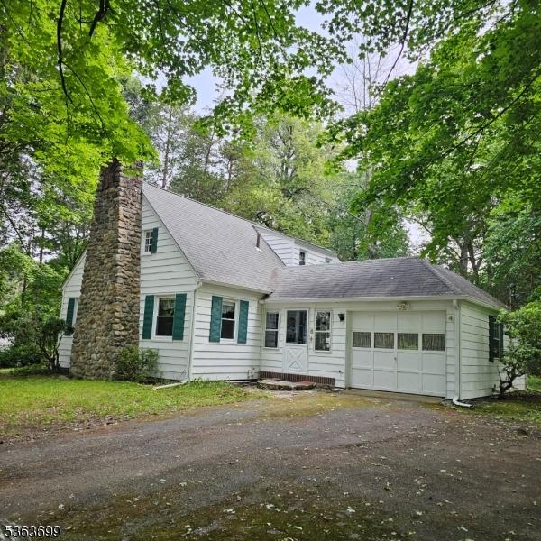 6 Penn Ave, Andover Twp, NJ 07860 - view of front facade with asphalt driveway, a garage, roof with shingles, and a chimney