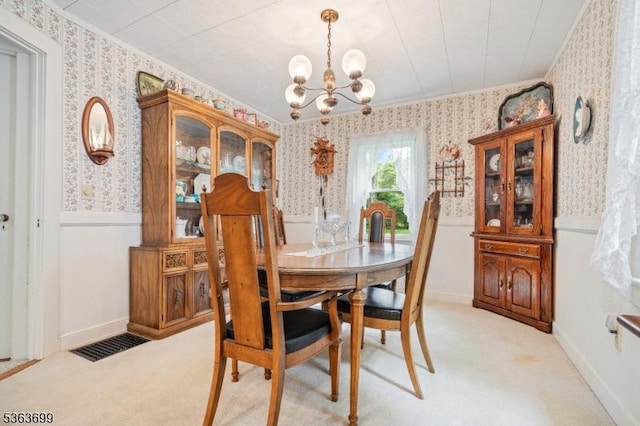 6 Penn Ave, Andover Twp, NJ 07860 - dining area featuring wallpapered walls, a chandelier, a wainscoted wall, light carpet, and crown molding