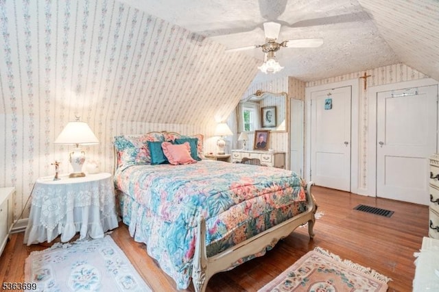 6 Penn Ave, Andover Twp, NJ 07860 - bedroom with wallpapered walls, wood finished floors, vaulted ceiling, and a ceiling fan
